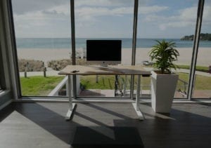 stand desk with imac against beach background