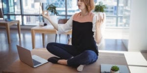 woman in meditation seat with apple laptop