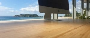 bamboo desk with imac and ocean background
